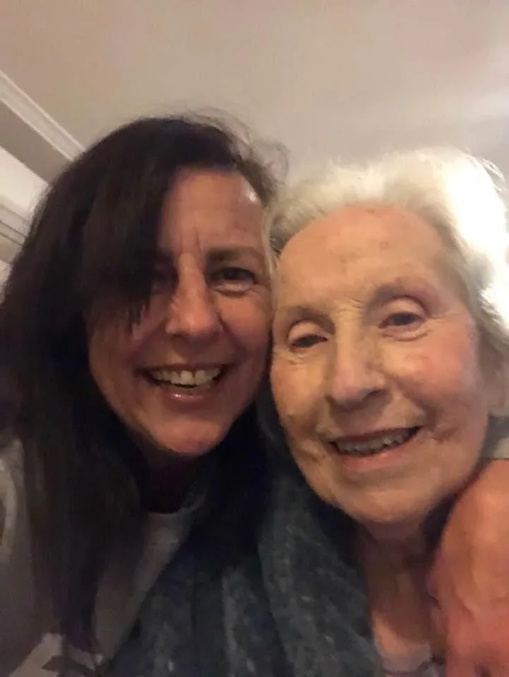 Terri and Joan cheek to cheek and smiling at the camera