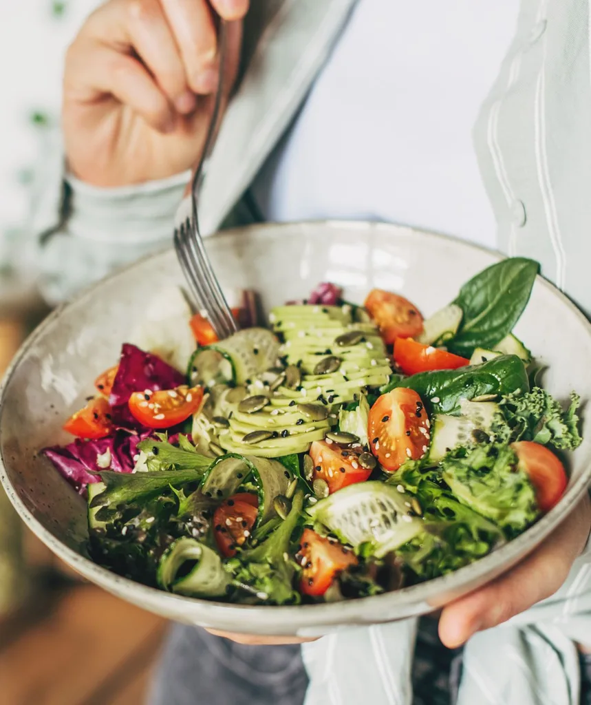 Woman holding a plate of salad