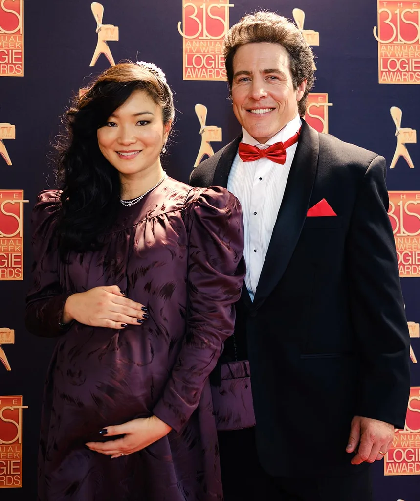 Michelle Lim Davidson, as Noelene, and Stephen Peacocke, as Rob, pose on the Logies red carpet in The Newsreader.