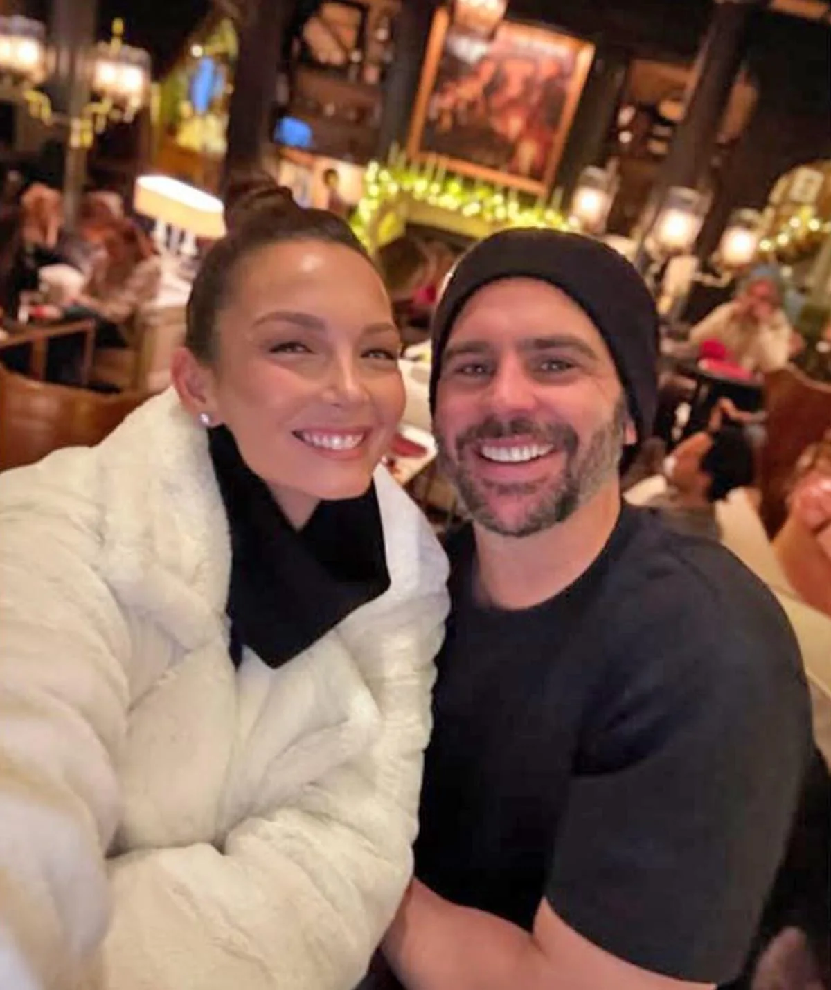 Ricki-Lee Coulter poses, smiling, with her husband Rich Harrison