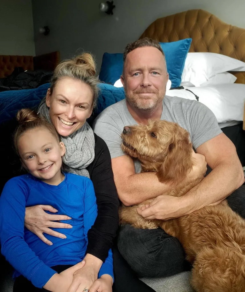 Mel poses with her husband, sister and their dog in a candid Instagram snap.