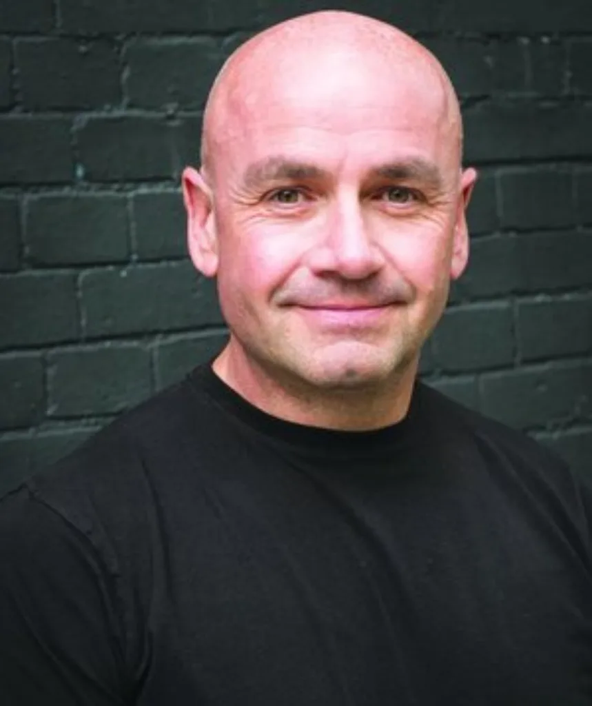 A colour image of a man smiling.