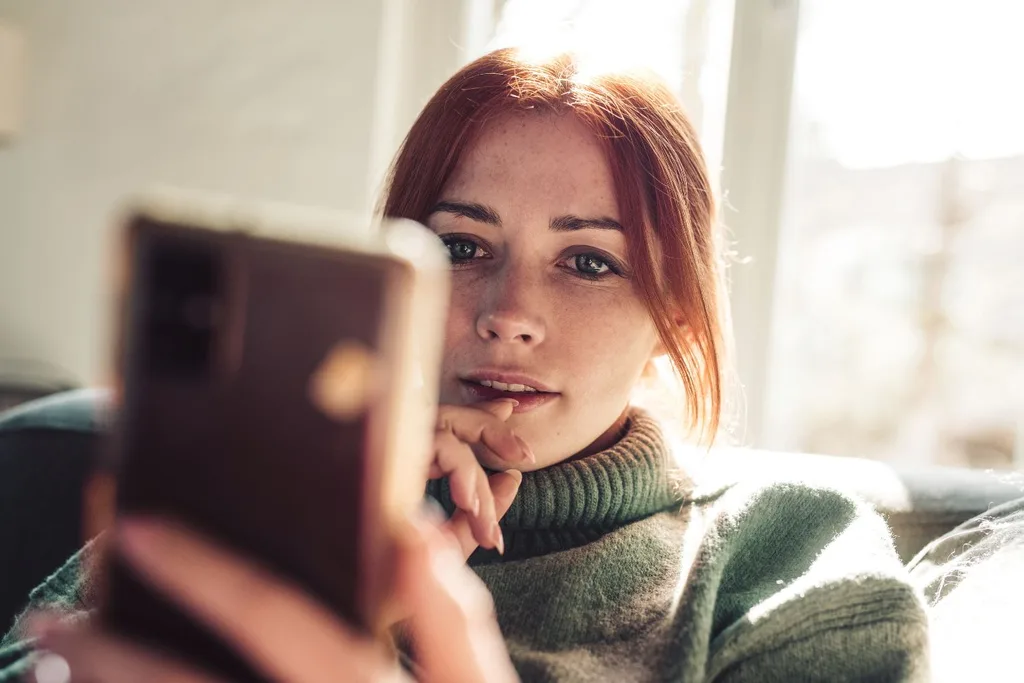 woman looking at her phone