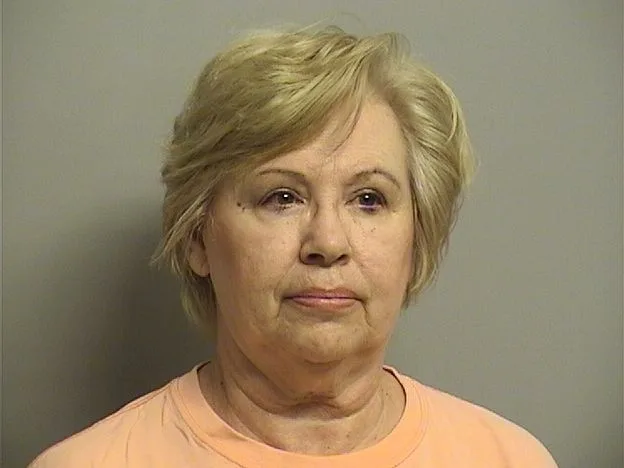 Judith with short blonde hair in light orange t-shirt