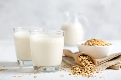 Oat milk. Healthy vegan non-dairy organic drink with flakes