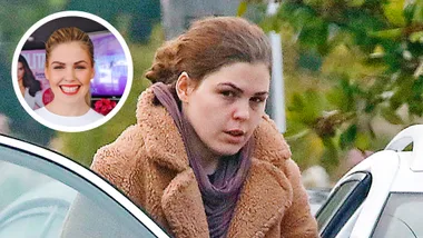 Main image of a brunette woman looking downcast in a brown coat. An inset of the same woman in white top with big smile.