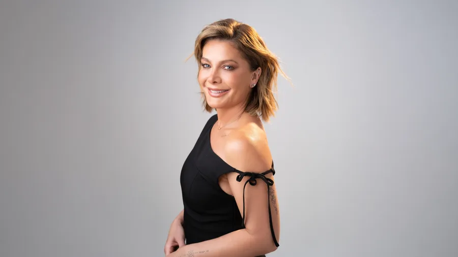 Natalie Bassingthwaighte in a black dress smiling