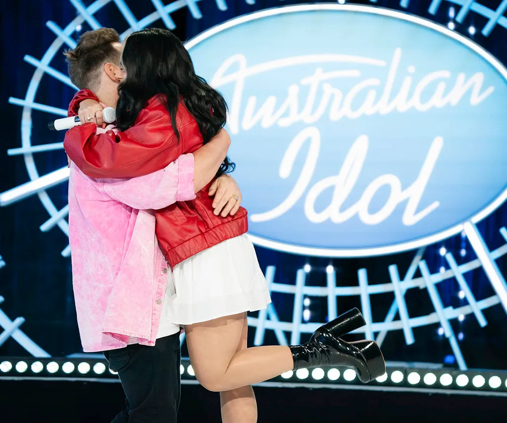 Chris and Jazz, a married couple auditioning separately for Australian Idol, hug each other on the audition stage