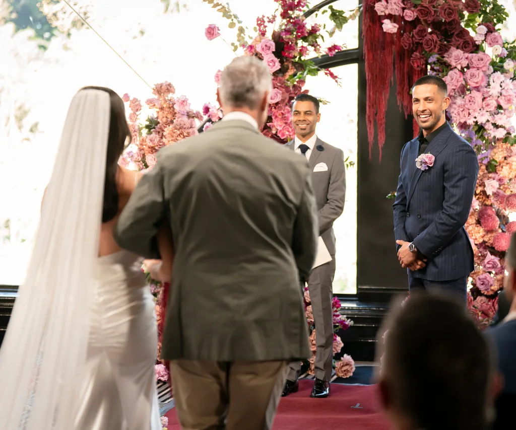 Beth walking up the aisle with towards Teejay her dad