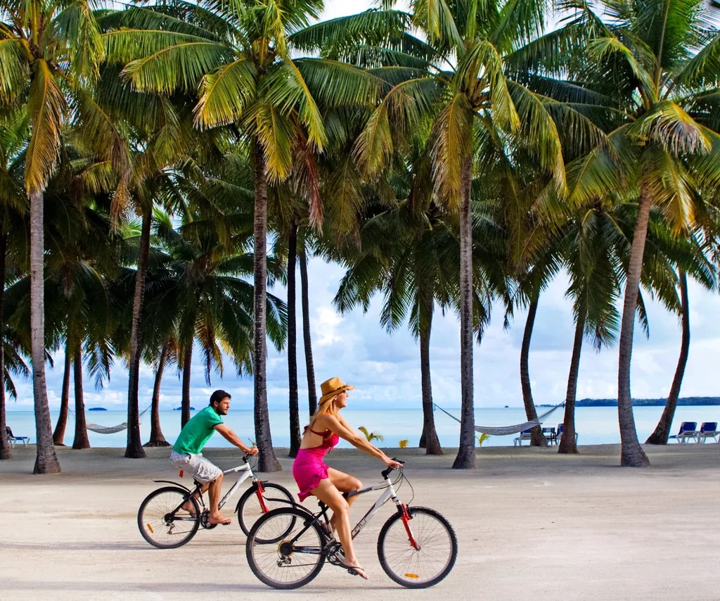 Catriona and Paul riding bikes in the Cook Islands on their original honeymoon in 2008