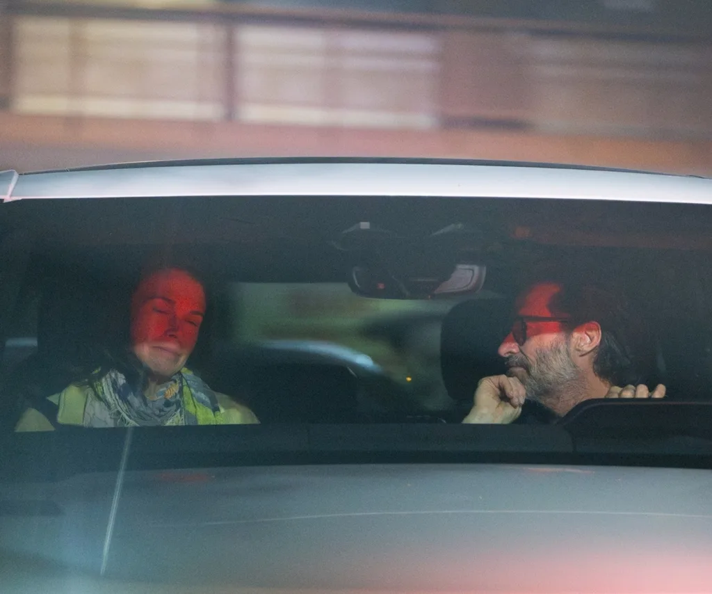 An image of a couple inside a car looking tense.