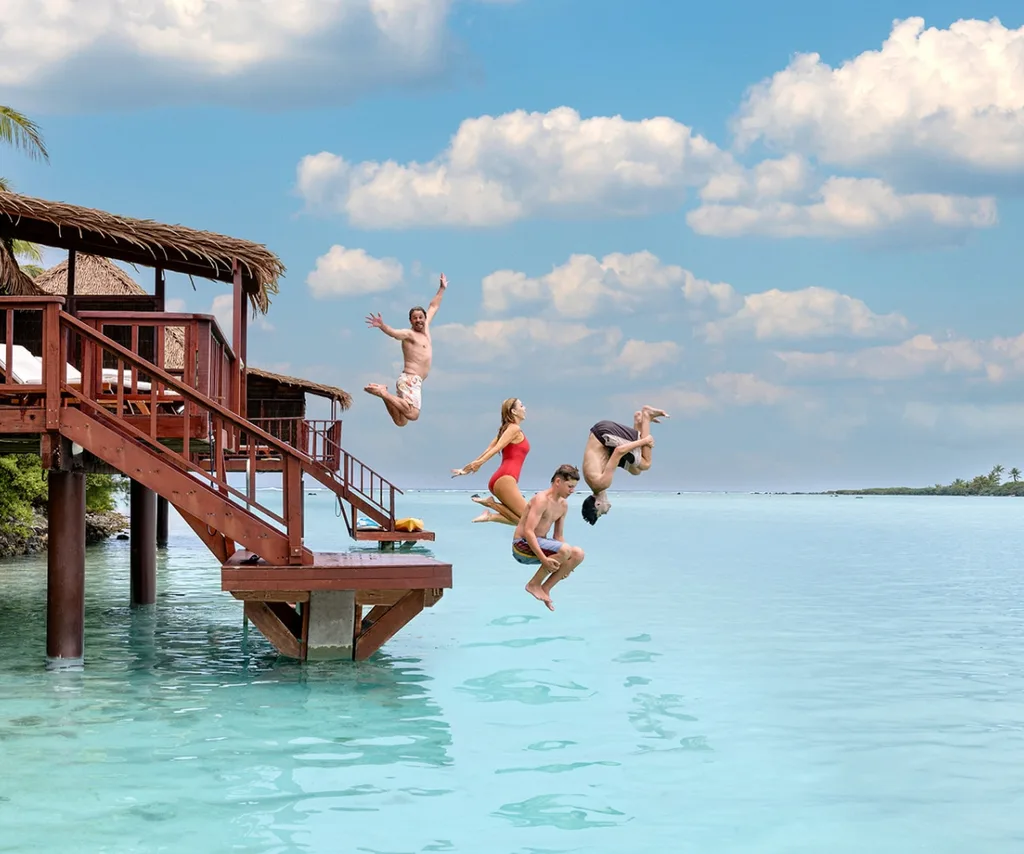 Catriona and family jumping into the water from their bungalow