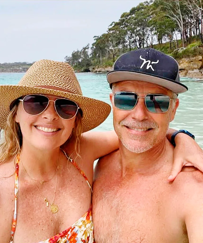 Alison Brahe puts her arm around husband Cameron Daddo. The two of them are dressed for swimming.