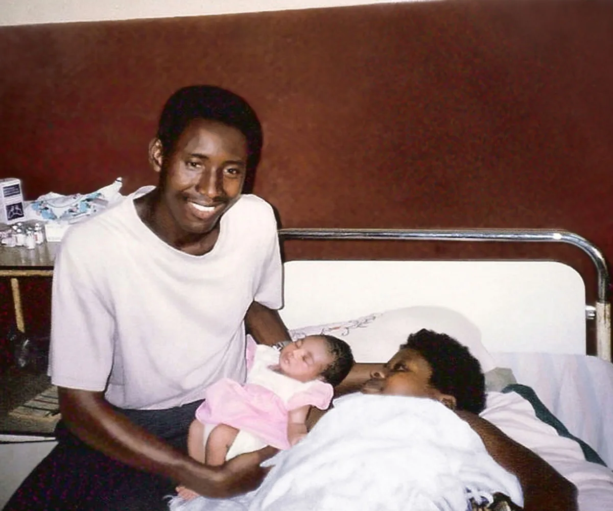 Me with my husband Augustine cradling newborn Regina at the hospital, just moments after my life-changing C-section. (Image: Supplied)