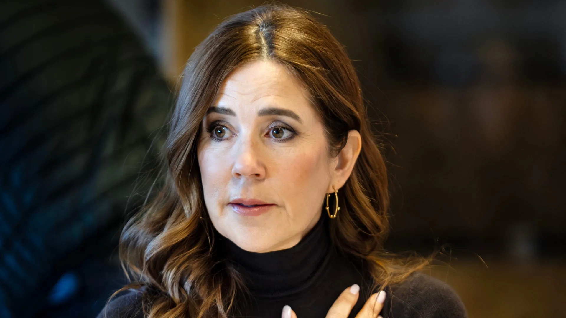A brunette woman is looking worried.