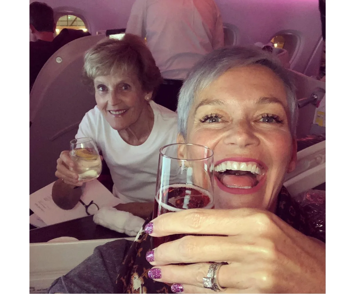 Penelope and Jess pose for a selfie on a plane