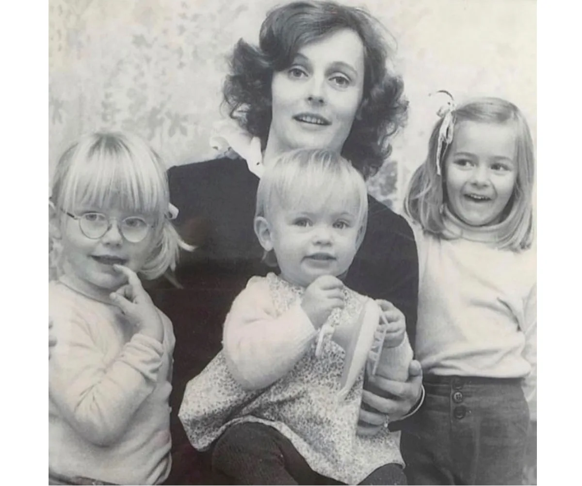 Penelope Rowe poses with her daughters as children in a black and white image