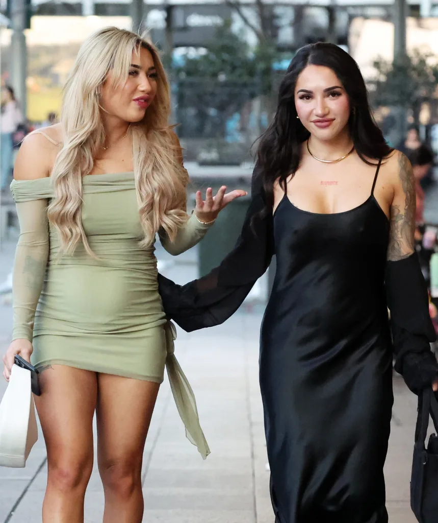 Awhina and Cleo stroll down the street arm in arm