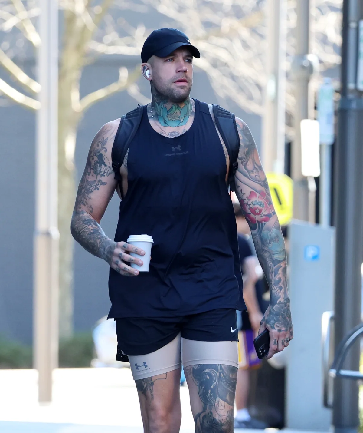 Dave Hand walks through the streets with a coffee