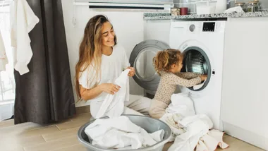 woman and child doing laundry