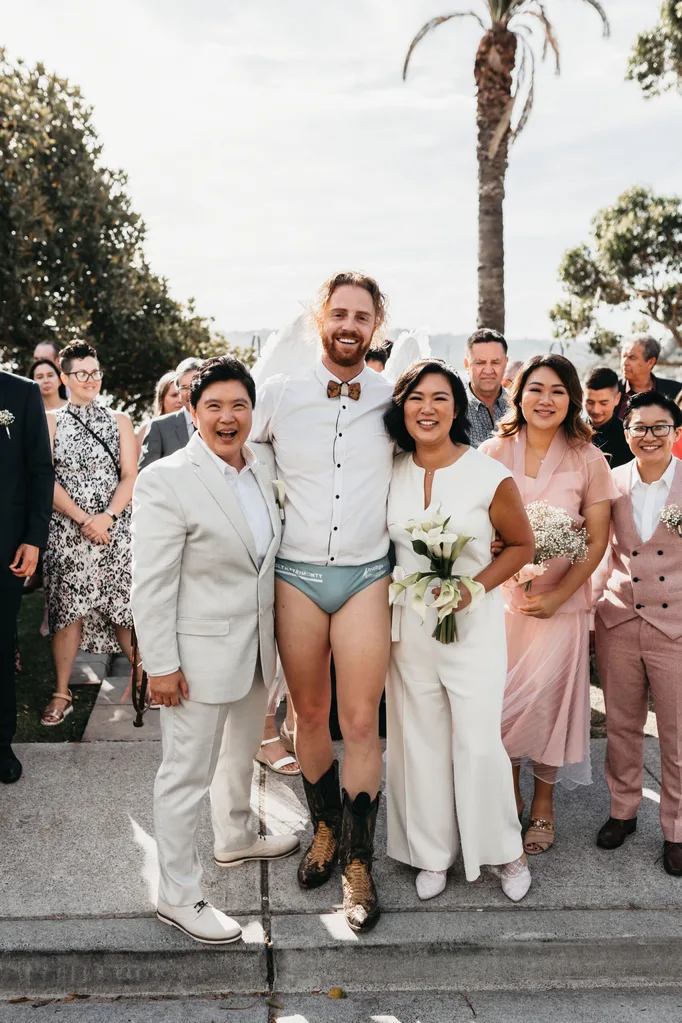 Monty Haron officiates a wedding for Leona and Popie in budgie smugglers