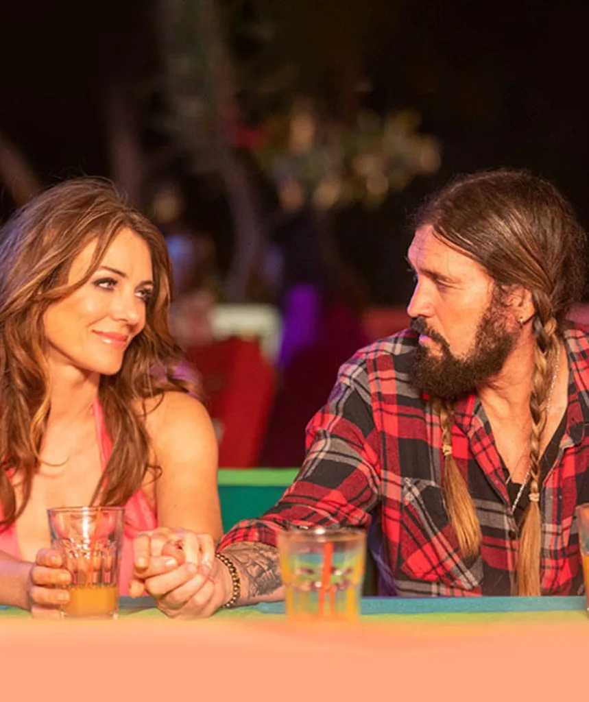 A man and woman look at each other.