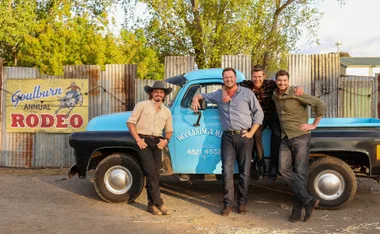The four farmers - Jarrad, Corey, Tom and Thomas - stand in front of a blue truck at the Goulburn rodeo.