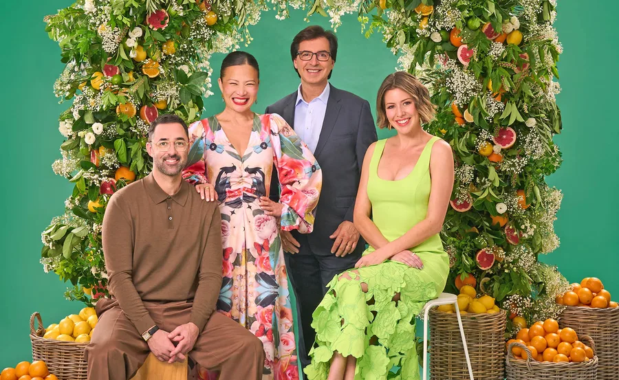 From left to right judges Andy Allen, Poh Ling-Yeow and Jean-Christophe Novelli and Sofia Levin pose for a promotional shot in an arch made up of leaves and fruits and surrounded by baskets of lemons and oranges