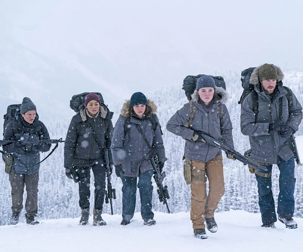 A group of Fireflies storm through the snow to ambush the camp where Ellie and Joel seek refuge