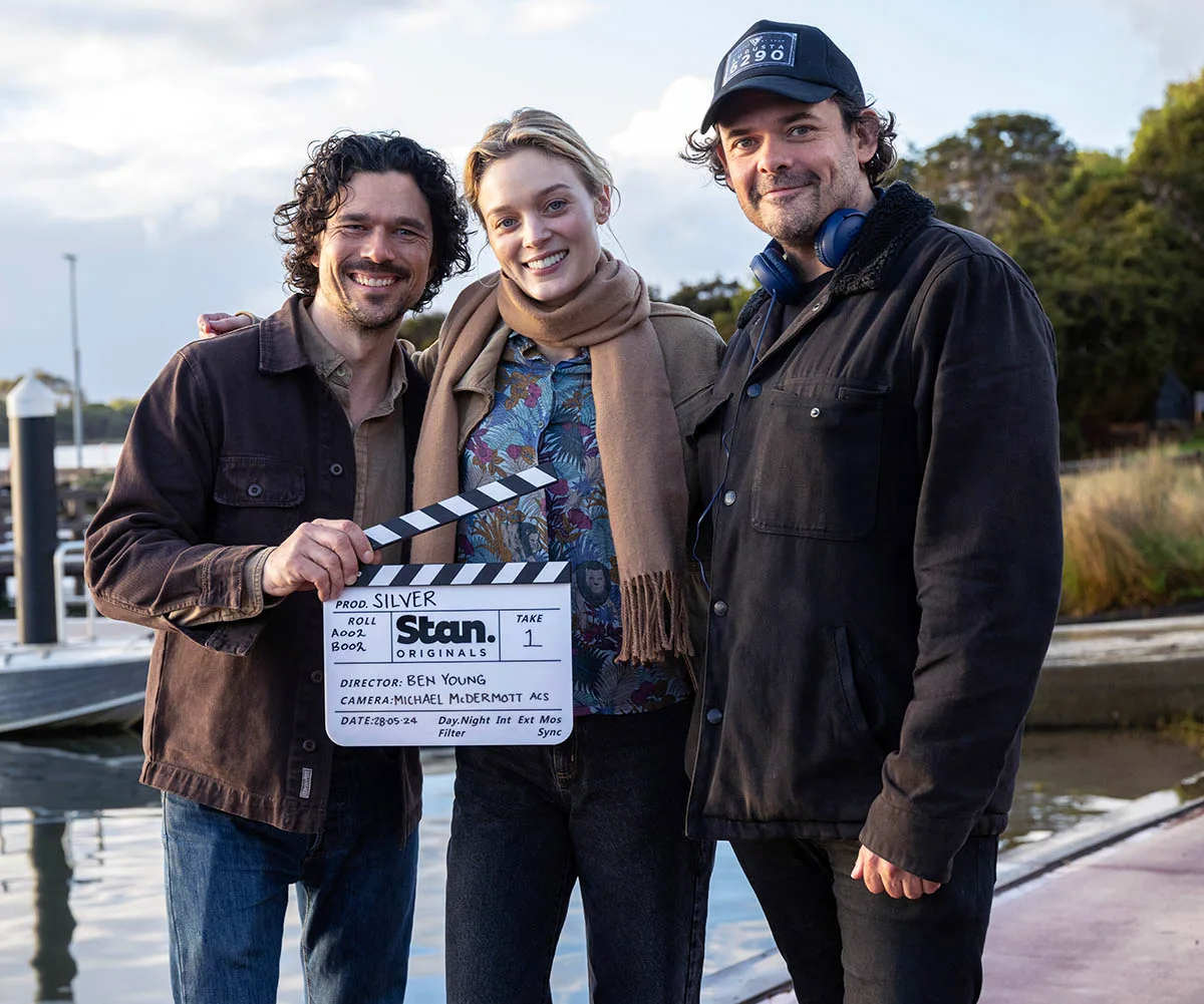 Luke and Bella with Silver director, Ben Young smiling as they prepare for a scene