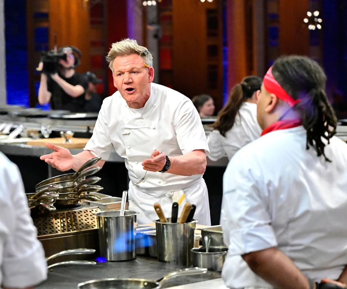 A man in chef's uniform looks angry.