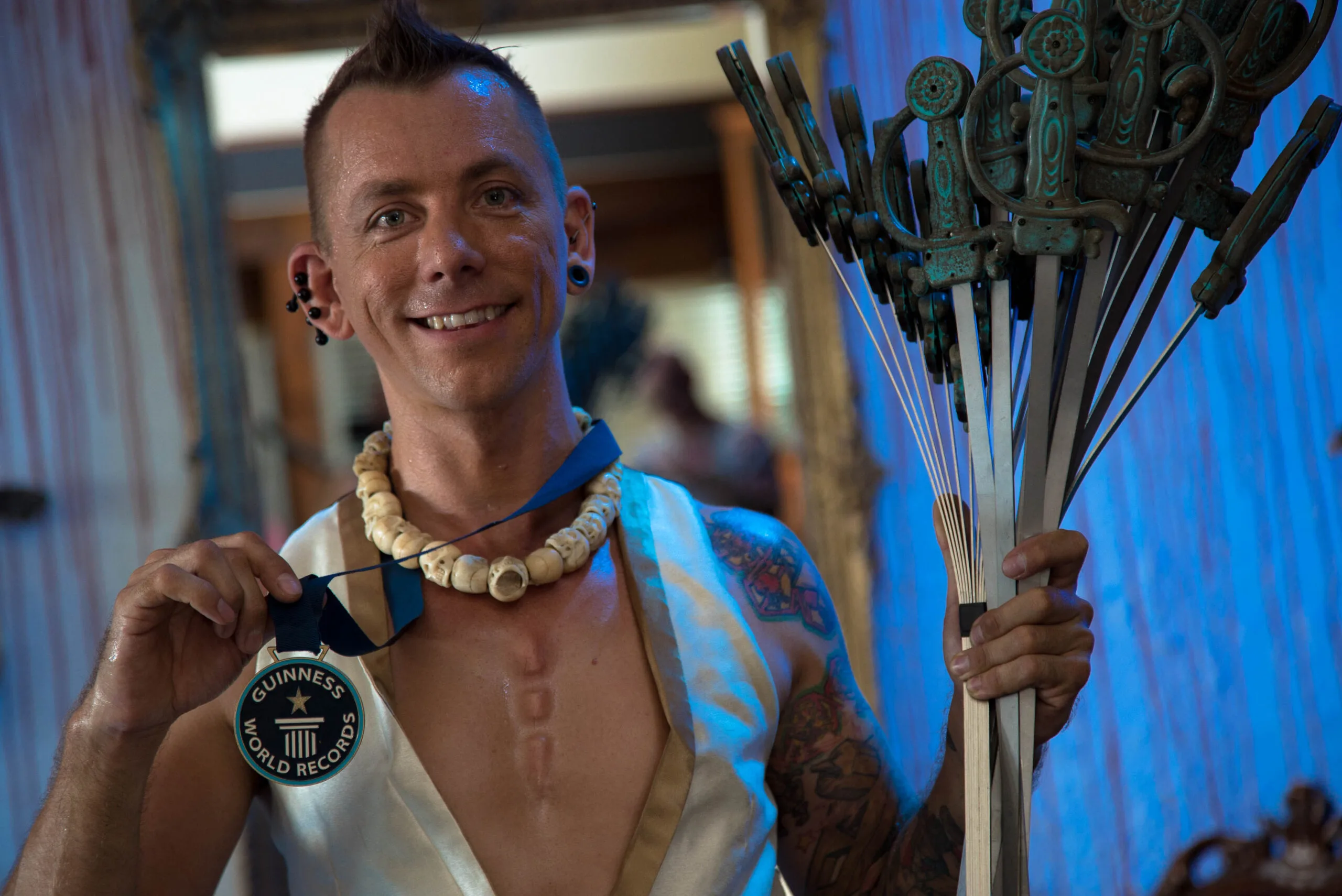 The Space Cowboy Chayne Hultgren, after breaking the world record by swallowing 17 swords at the same time. (Image: Ollie Grainger)