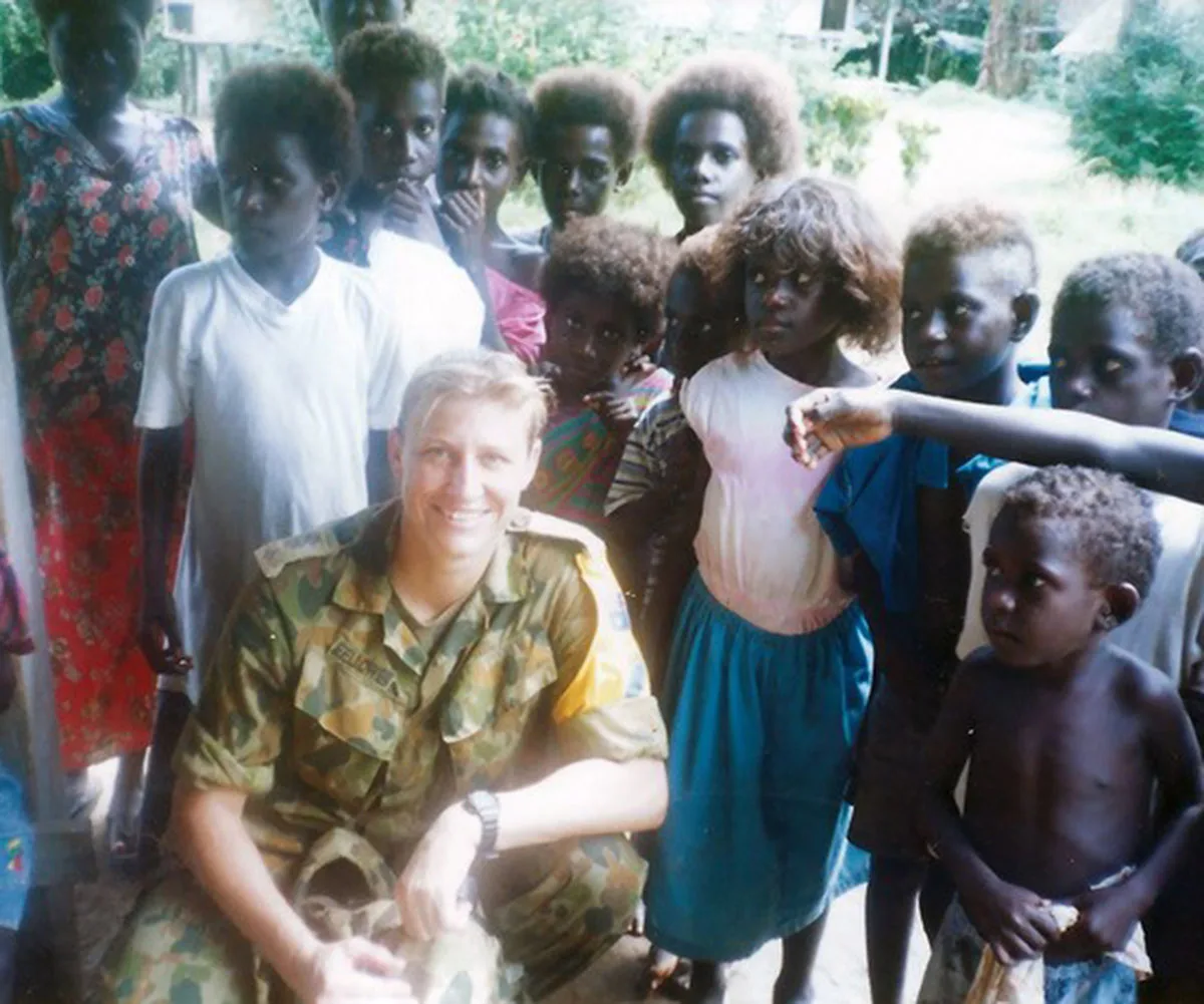Me while serving in Bougainville in 1998 and meeting with the children. (Image: Supplied)