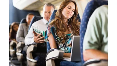 A woman sitting on a plane.