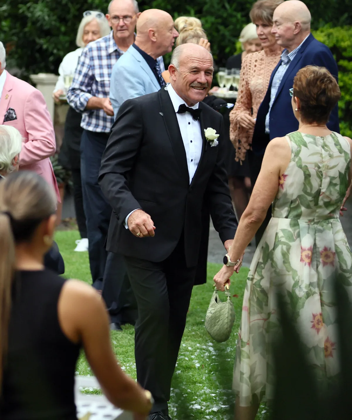 Wally Lewis makes his way through the crowd after the wedding.