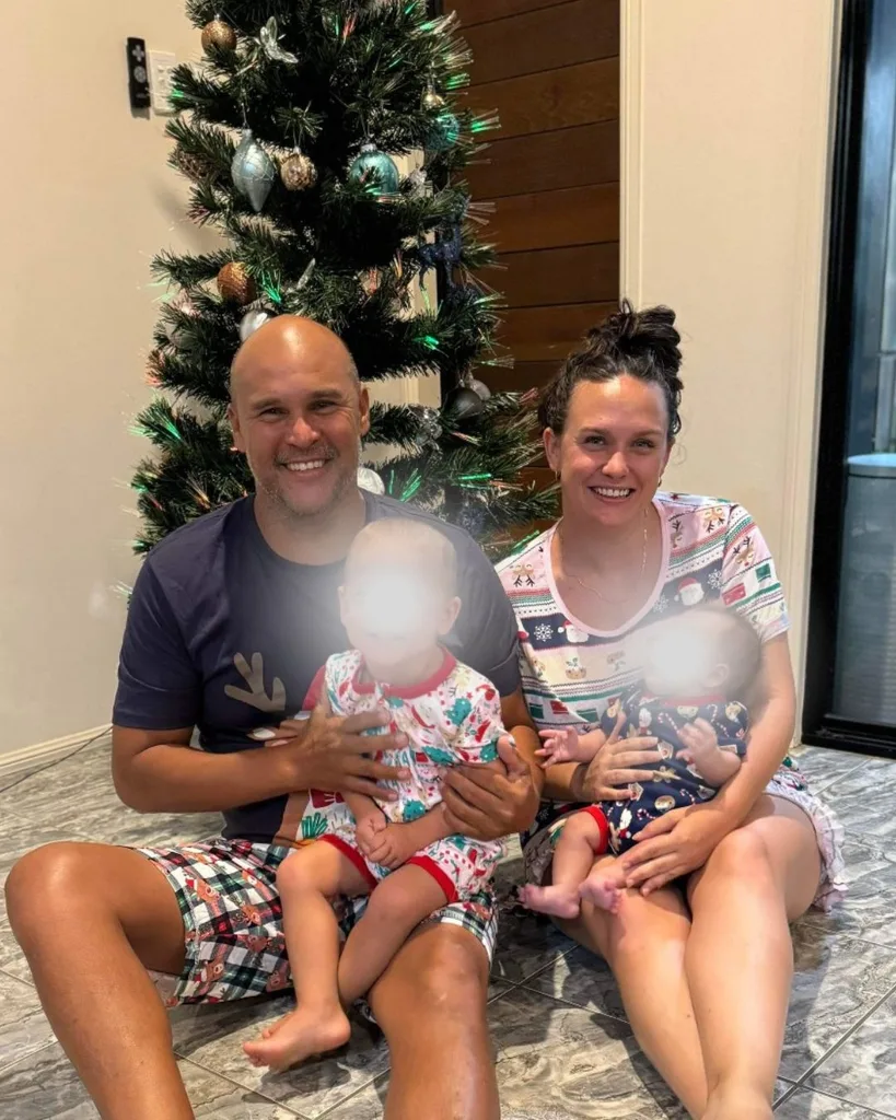 Tahlia with her husband and children in front of Christmas tree