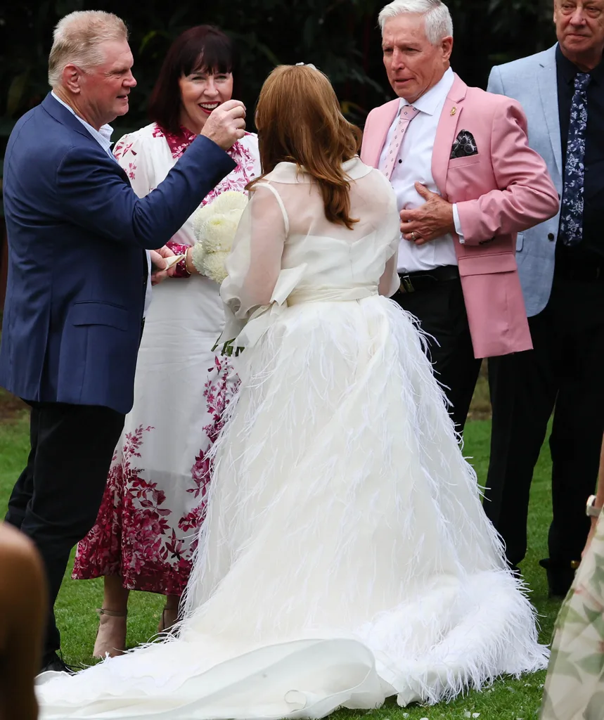 Lynda shows off her wedding dress from the back.