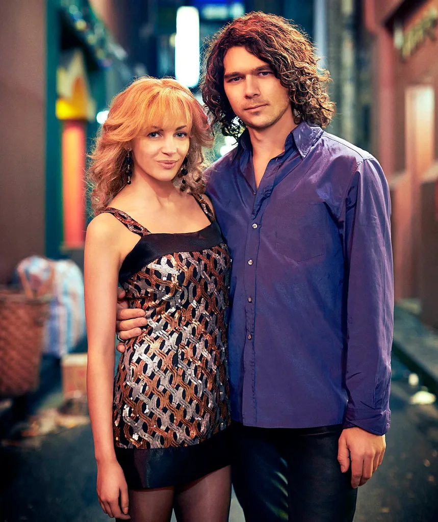 Samantha Jade in a disco style dress appearing as Kylie Minogue and Luke Arnold as Michael Hutchence with longer shaggy dark hair and a blue button up shirt