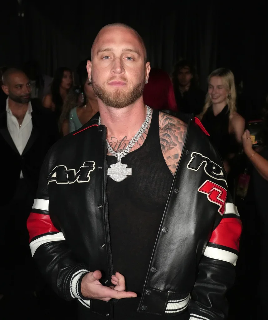Chet Hanks poses in a biker jacket at an event