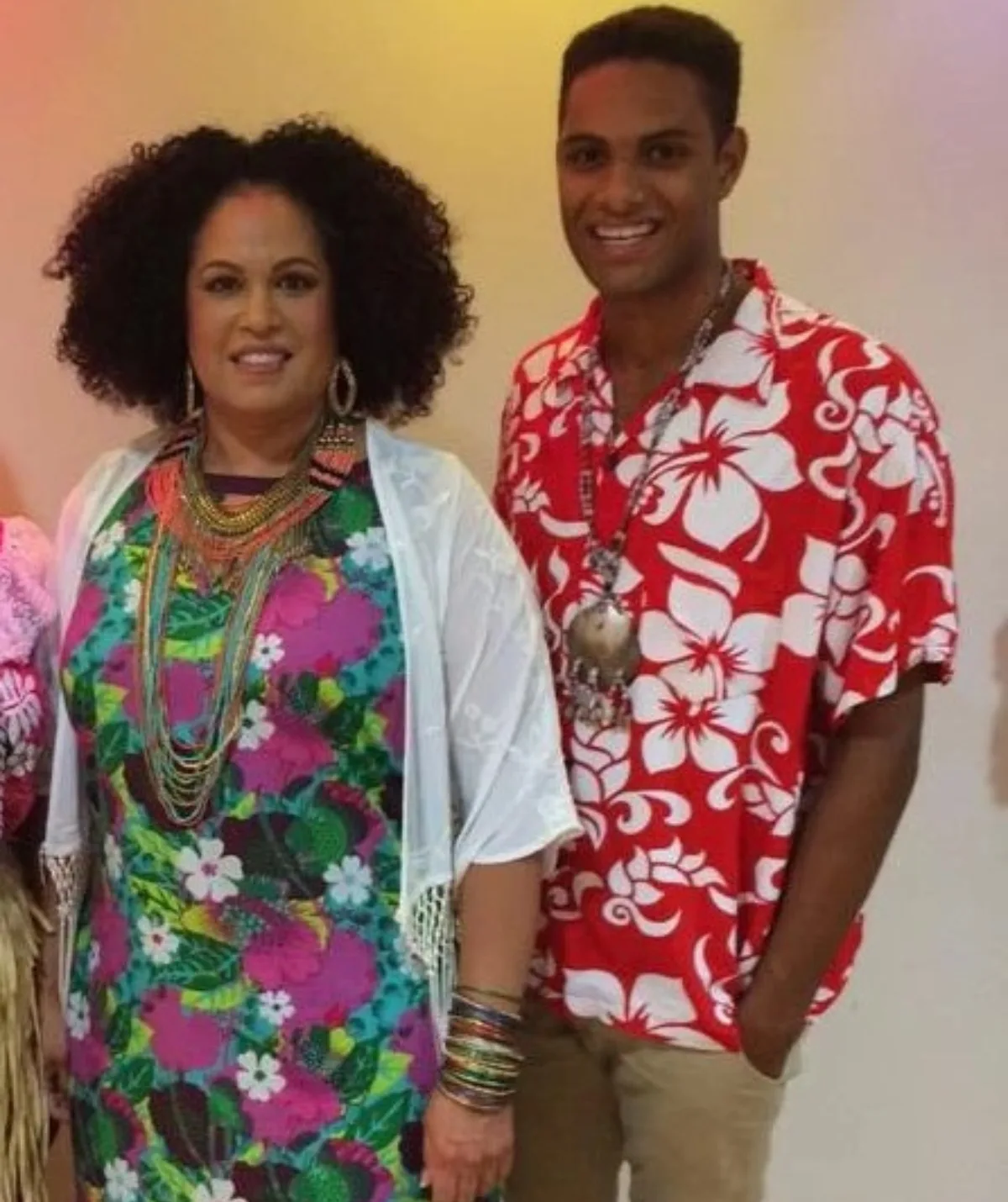 A Black middle aged woman and a Black young man are smiling to camera. 