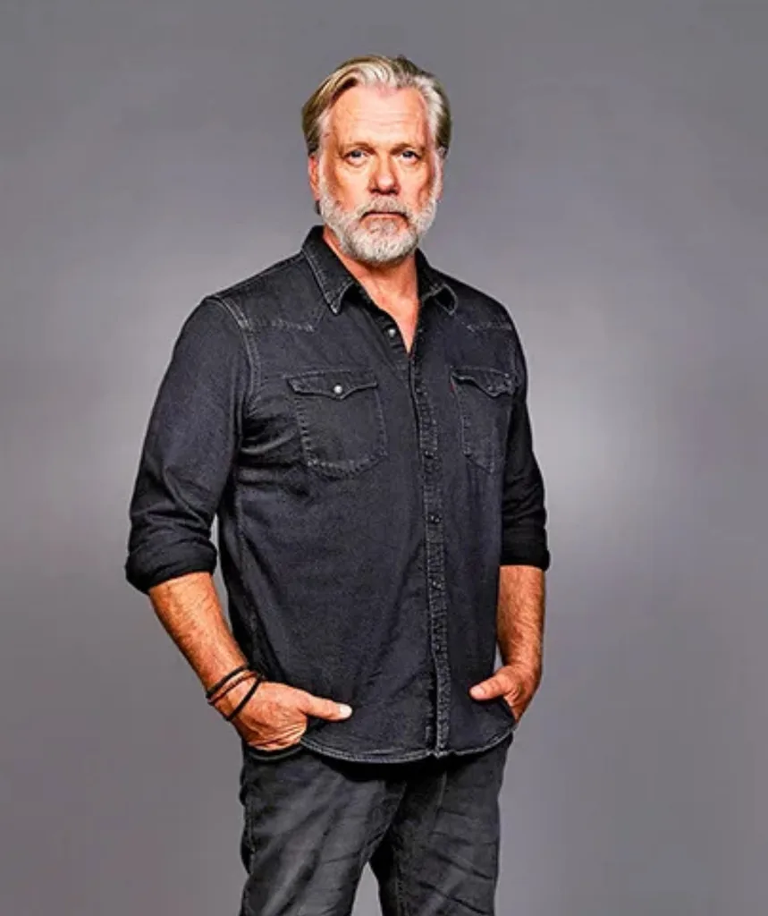 A man wearing all black with hands in pockets.