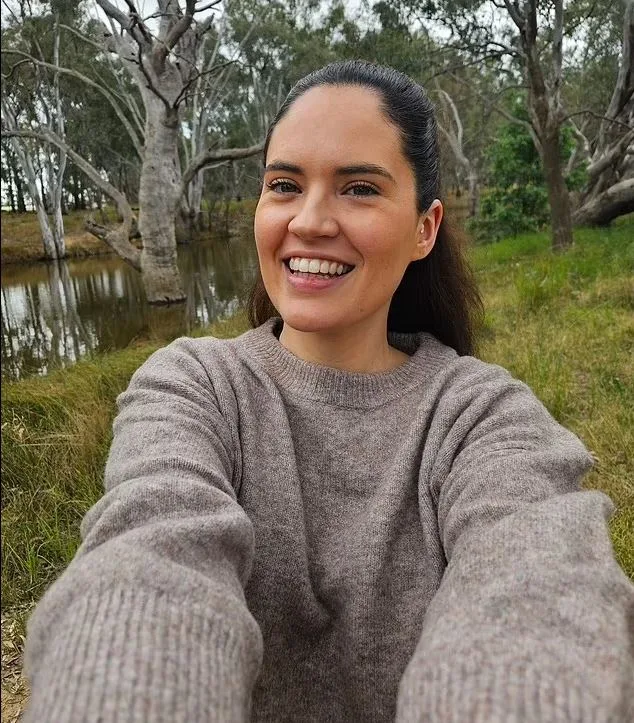 Zoe taking a selfie while surrounded by lush green bushland