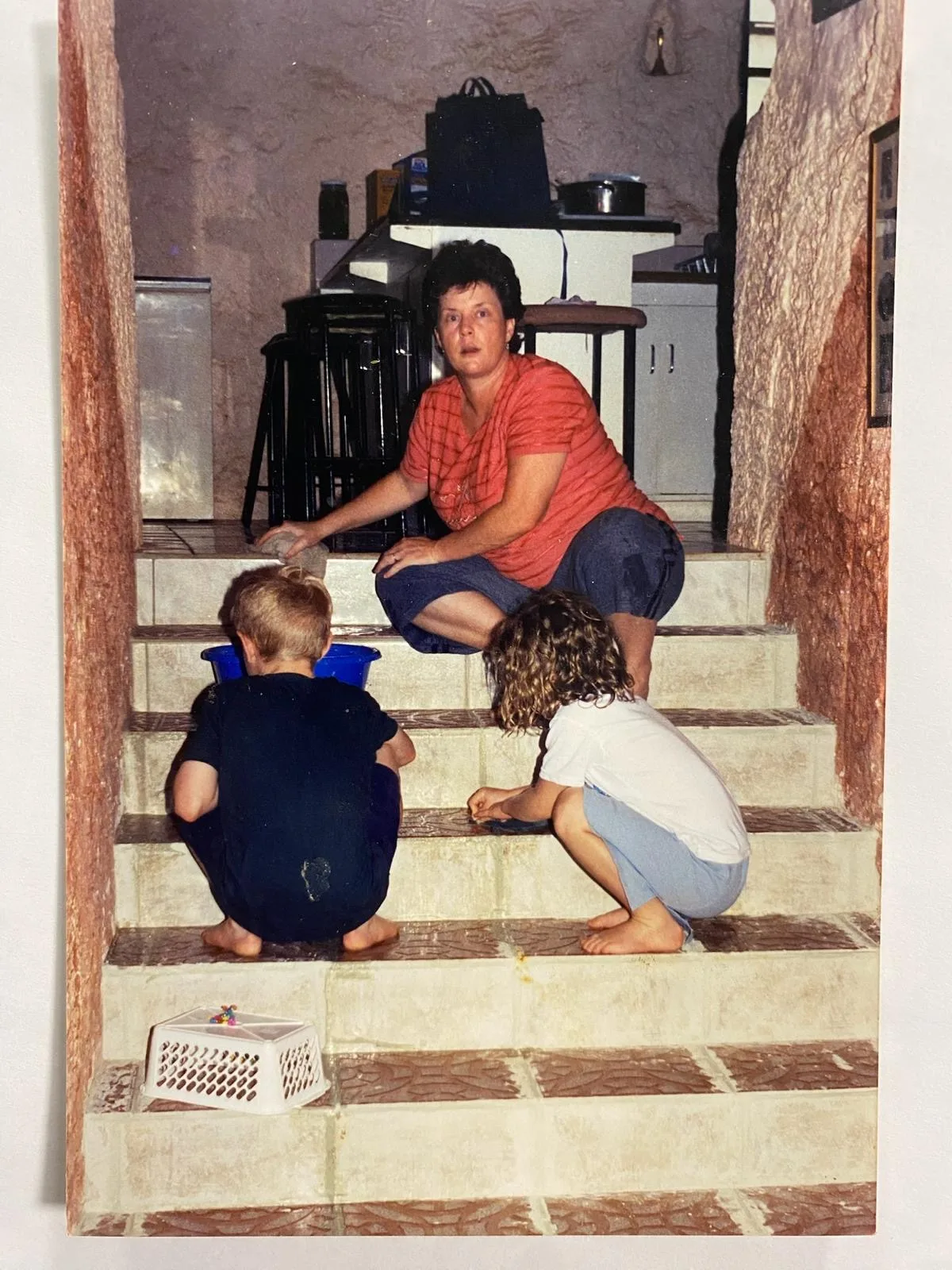 Bethany's brother Joel, Bethany's mum and Bethany grouting tiles