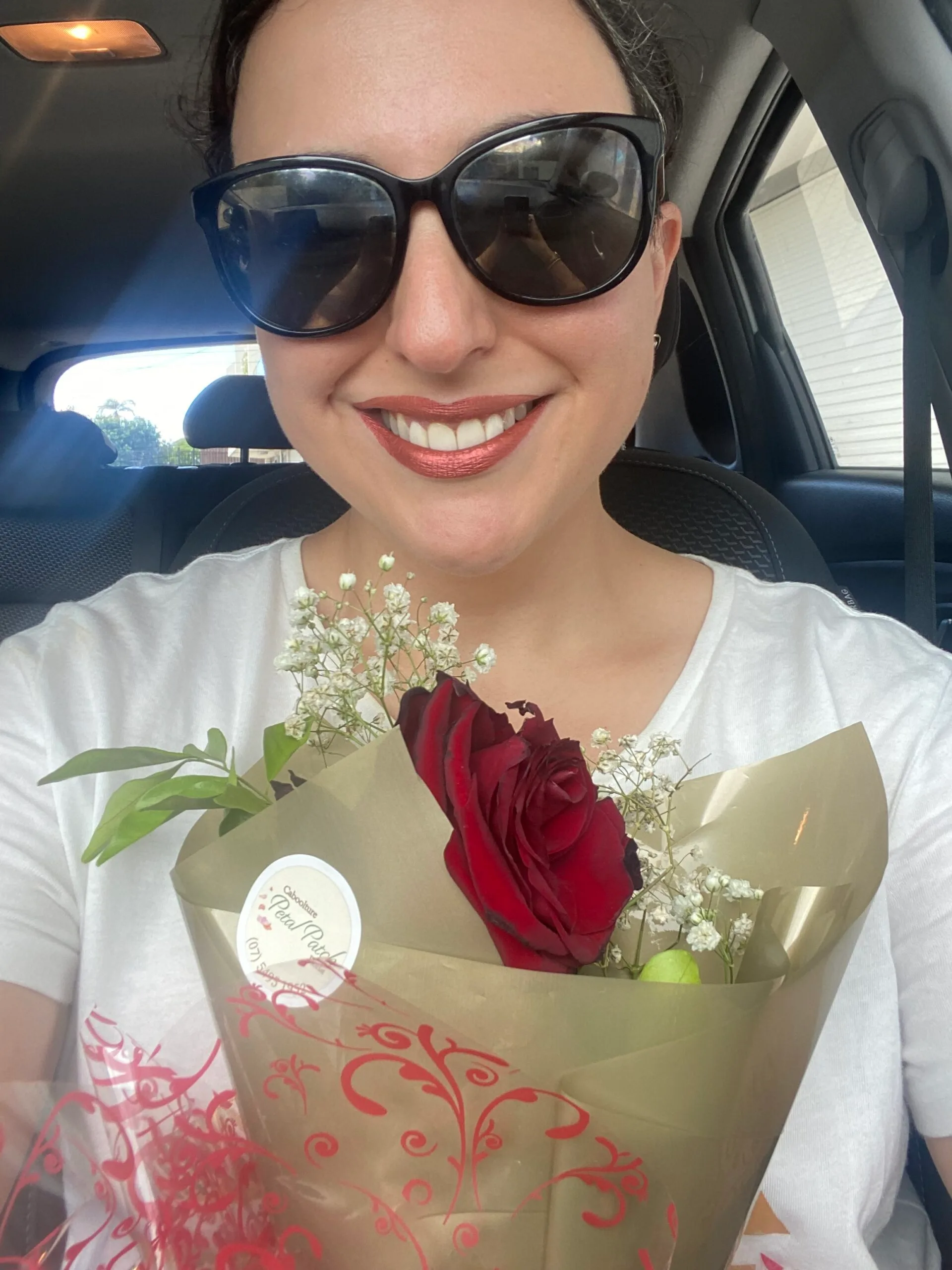 Elinor holding a rose she'd been given by Daniel