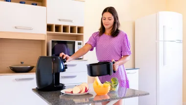 Woman using air fryer