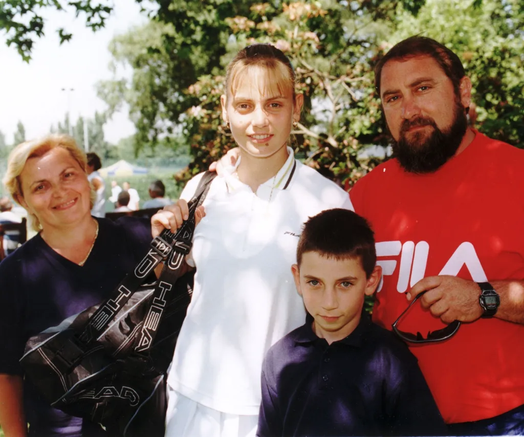 Jelena as a teen poses with her mother and father and brother.