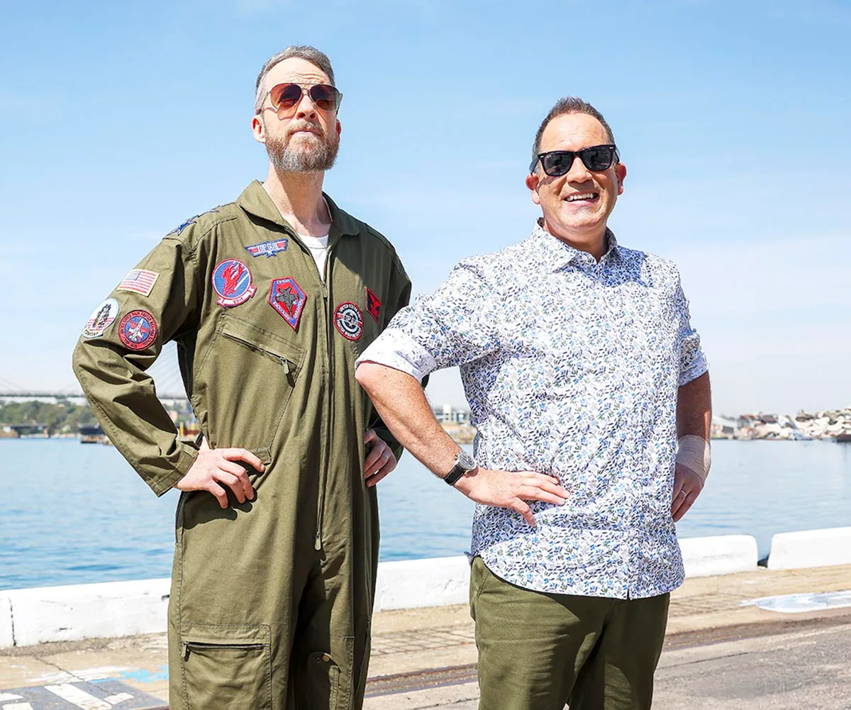 Hamish and Brickman pose with their hands on hips, looking proud. 