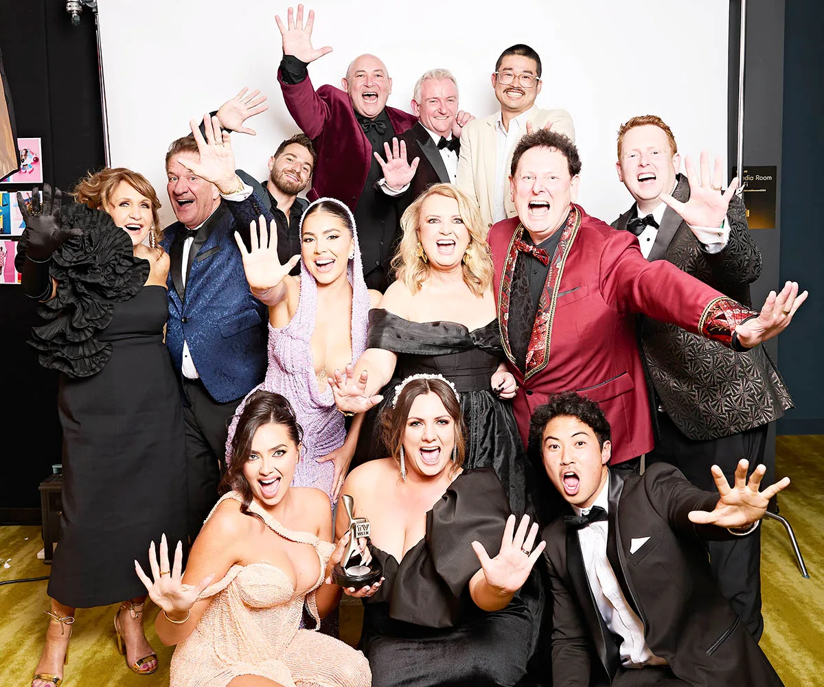 The Fren family, and other people involved with Travel Guides, pose with their Logie, just after their win. 