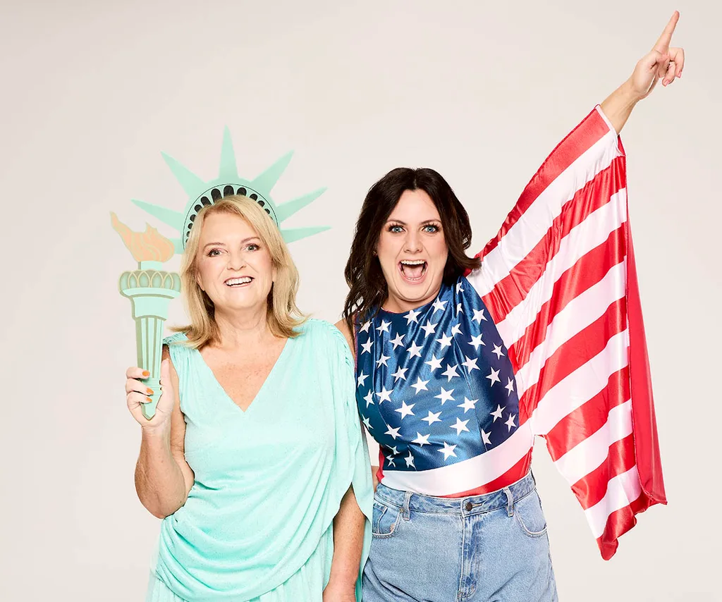 Cathy Fren poses dressed as the Statue of Liberty, while Victoria Fren stands next to her wearing an American flag