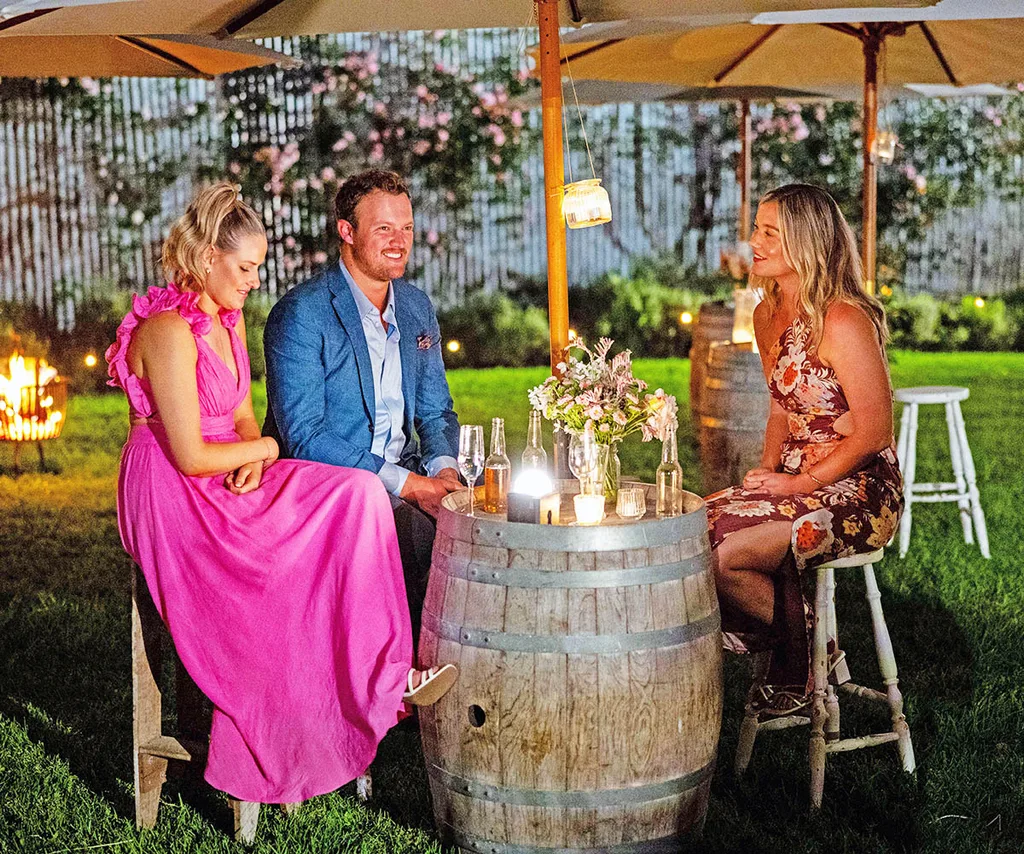 Keeley, Corey and Chloe sit around an outside table at the country ball